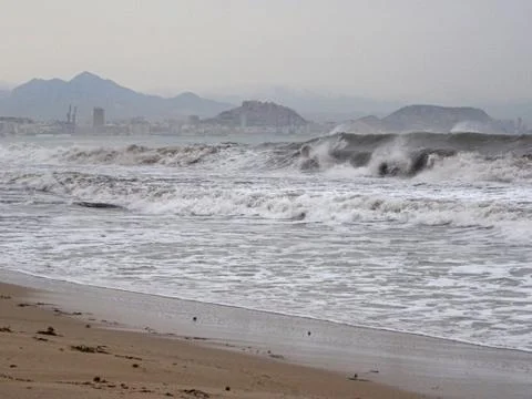 View of the beach with strong waves in a bad weather day Stock Photos