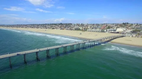 View of Beach Town with Dock From Beach to Ocean by Aerial Drone Vídeos de archivo 66484555