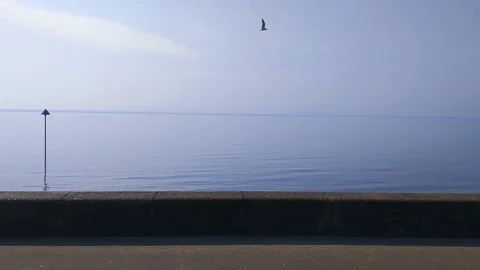 View of a beach water gently breaking against the shore Stock Footage 128388949