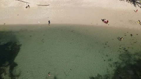 The view on the beach when people are swimming Video stock 235372645