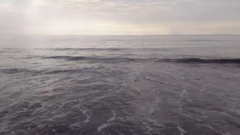 A view of beach when sun is covered by clouds near horizon. Stock Footage 271634326