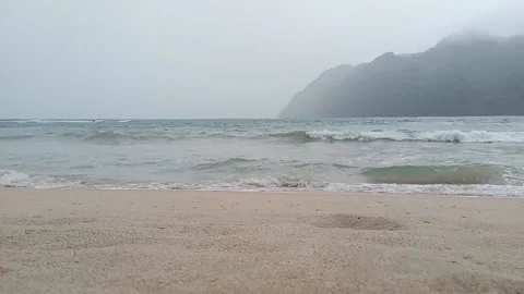 The view of the beach with white sand and the island in front in a drizzling atm Stock Footage 202241813