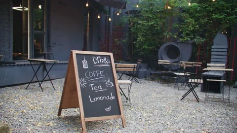 View of beautiful cafe outdoors. Space terrace with tables and chairs. Green Stock Footage 254674904