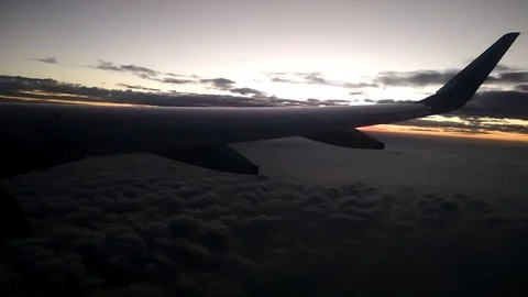 View of beautiful clouds and golden sunset lining from an aeroplane window Stock Footage 120821863