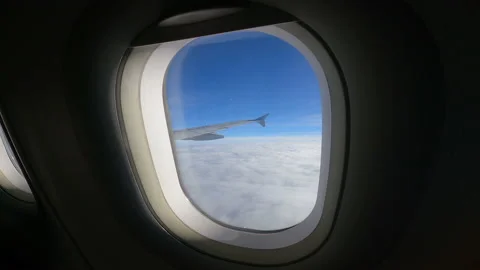 View of beautiful clouds and wing of airplane from window Stock Footage 147420144