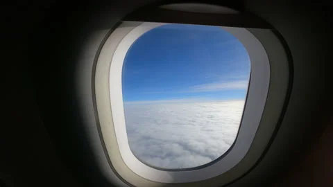 View of beautiful clouds and wing of the airplane from the window Stock Footage 147420188