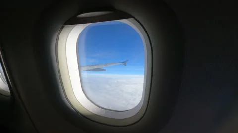 View of beautiful clouds and wing of the airplane from the window Stock Footage 147420226
