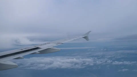 View of beautiful clouds and wing of airplane from window Stock Footage 152967091