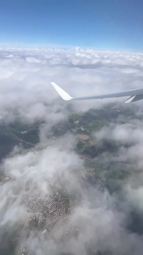 View of beautiful clouds from a plane window over a city Stock Footage 337094308