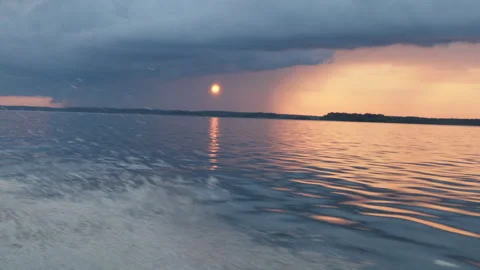 View of a beautiful evening summer sunset through the clouds with the reflection 스톡 동영상 280547735