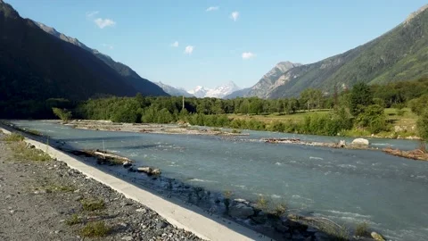 View of a beautiful gorge with a river and snow-white peaks in the distance Stock Footage 170728588