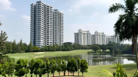 View of beautiful lake with golf course and high rise skyscrapers 스톡 동영상 287584477