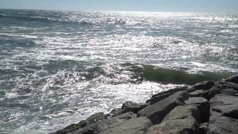 View of a beautiful ocean sandy beach with the blue waves rolling into the shore Stock-Footage 91247761
