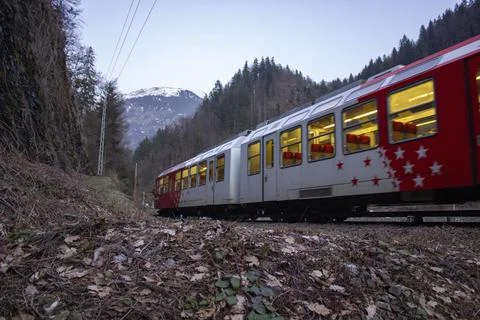 View of the beautiful red train in the mountains and forest Stock Photos