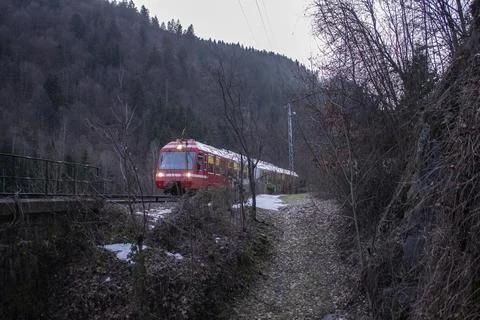 View of the beautiful red train in the mountains and forest Fotos de archivo
