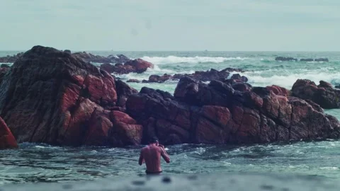 View of a beautiful rock to a diving man Stock Footage 241834555