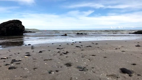 View of the beautiful rocky beach with waves	 Stock Footage 149321724