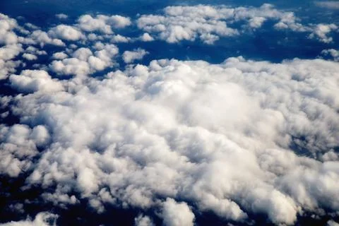 View of the beautiful sky and clouds from the window of the airplane Stock Photos