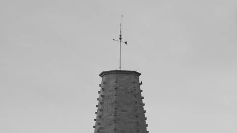 View of the beautiful spire of a medieval temple in the old town early morning Stockbeeldmateriaal 168313637