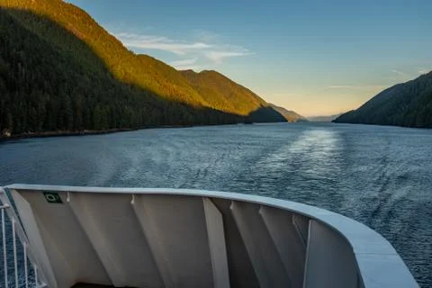 The view at a beautiful sunset from the back of a ferry as it makes its way t Stock Photos