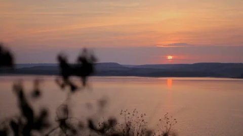 View of a beautiful sunset over the river through branches Stock Footage 90451683