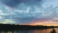 View of beautiful sunset reflecting in clean surface of river, relaxing nature HD Footage