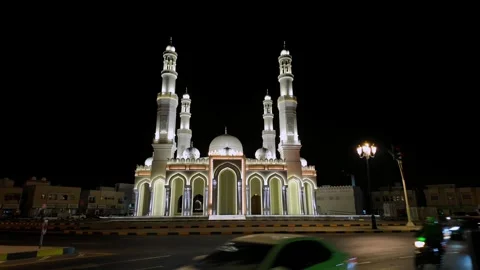 A view of a beautifully illuminated mosque at night in Sharjah, United Arab 動画素材 332047428