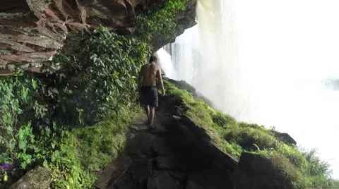 A view behid a raging and roaming waterfall Stock Footage 58646995