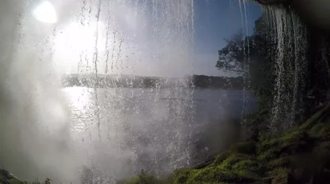 A view behid a raging and roaming waterfall Stock Footage 58647240