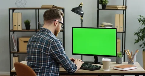 View from behind on the attractive man working at the office desk in front of Stock-Footage 89951806