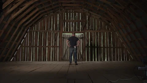View From Behind of a Blue Collar Working Man in an Empty Barn Video stock 219579333