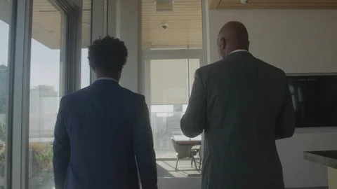 View From Behind of Businessmen Walking Down a Hallway Corridor Together Stock Footage 270291285