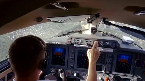 View from behind of a captain of plane and a pilot in flight deck, crew flying 動画素材 95048145