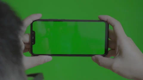 View from behind of caucasian man using smartphone with green screen Stock Footage 205582707