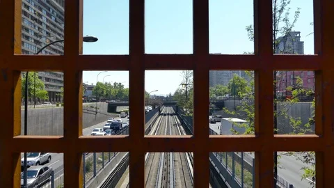 View behind grid of subway train leaving the station along the tracks Stock Footage 98115172
