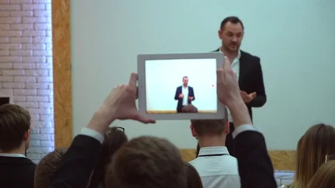 View from behind of a group of students in a classroom, listening as their Stock Footage 85007210