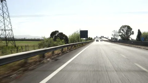 View from behind inside a car as it travels on the freeway. Stock Footage 239549350