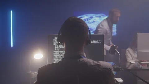 View From Behind of an IT Technician in a Dark Office Stock Footage 208766727