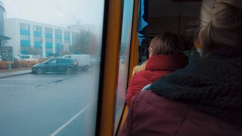 View from behind on a  passengers sitting in a bus along the windows Видео 118993599