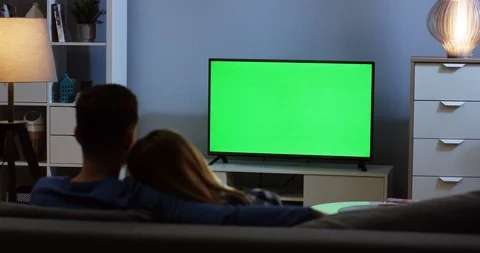 View from behind on the romantic man and woman hugging while sitting on the sofa 스톡 동영상 91051276