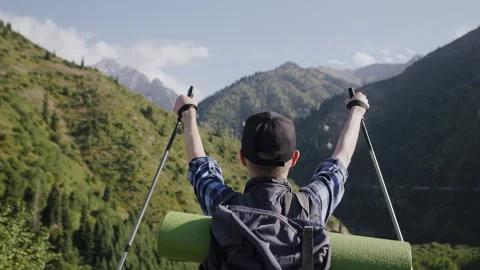 View from behind of a senior tourist with a backpack looking at the nature, and Stock Footage 254070860