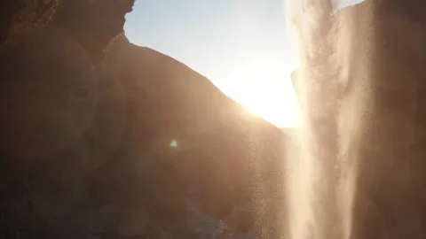 View from behind a waterfall in Iceland with sunset Stock Footage 158746856