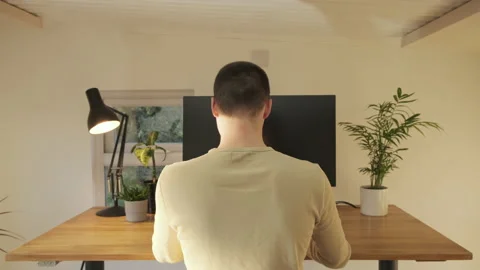 View from behind as a young professional stands while working from home Stock Footage 142615638