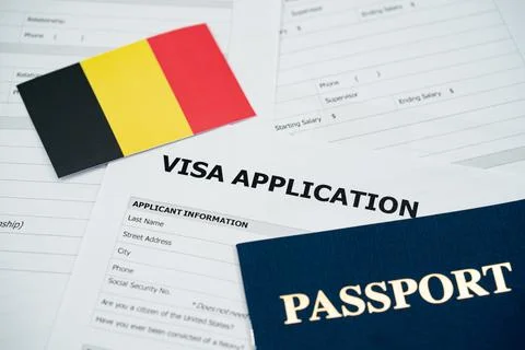 View of Belgium visa application form with passport and national flag Stockfoto's