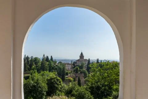 View of the bell tower of the Alhambra through the arched window from the Gen Stock Photos