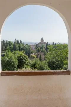View of the bell tower of the Alhambra through the arched window from the Gen Foto stock