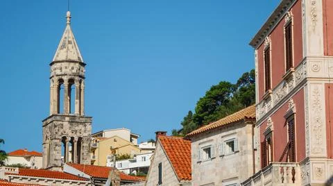 View of the bell tower of Hvar Cathedral of Saint Stephen and house roofs Stock Photos