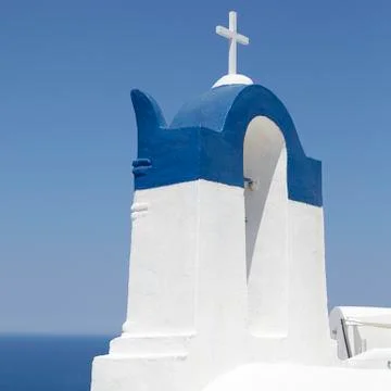 View of a bell tower with the sea at the background in Oia Santorini, Greece Stock Photos