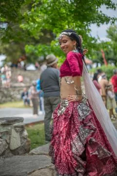 View of a belly dancer, dressed in typical clothes, in medieval fair Stock Photos