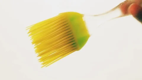 View from below as a cooking brush smears ketchup with herbs for cooking steak Stock Footage 122619921